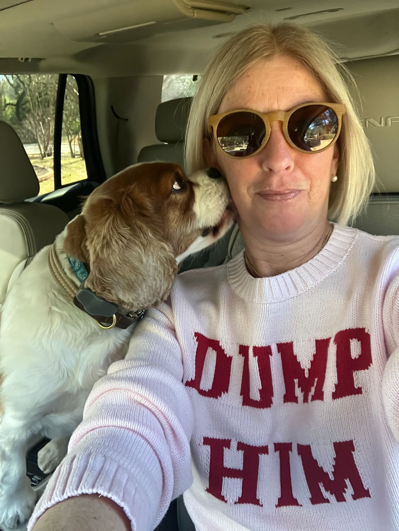 Founder in a Dump Him sweater with her dog